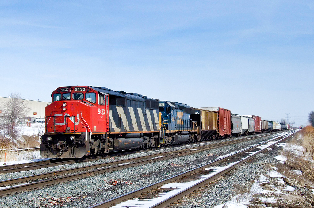 CN SD50F 5433 and CSXT SD40-2 8848 depart MacMillan Yard via the Halton Outbound with Toronto, ON - UP Chicago Proviso, IL train M39331 09.