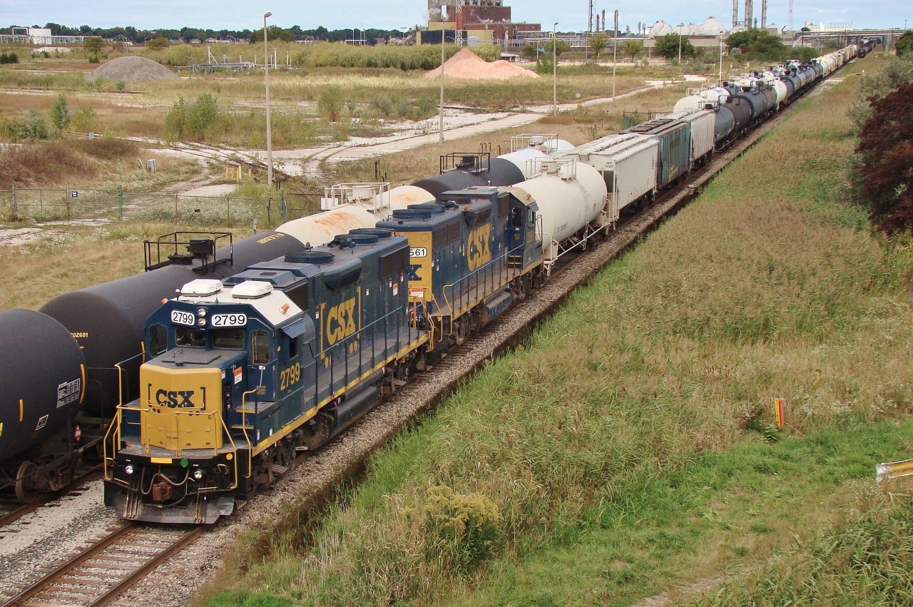 The transfer from CN is seen here backing up towards the yard behind them in the distance. This job requires a caboose/ shoving platform as they shove about two miles North from Lasalle Rd. to Sarnia Yard. The empty grassland to the left used to be a massive chemical complex occupied by the Dow Chemical Company, who closed down the plant in 2009.