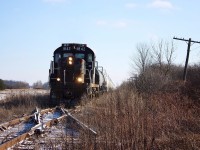 In just over a week the St. Thomas & Eastern will cease operations over the former CN Cayuga sub. RS18 1842 leads a sizeable train past the ghost diamond with the abandoned Canada Southern.