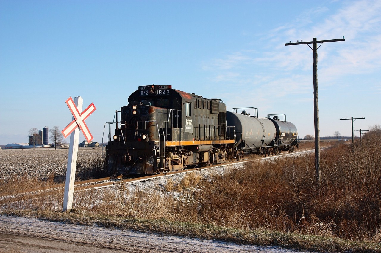 One of the last St. Thomas & Eastern westbound for St. Thomas rolls through farmland just east of Alymer with two cars from Tillsonburg. Old telephone poles still stand tall along the old Canada Air Line rails here. The tracks east of Alymer may not survive the next year with the end of the STER.