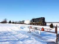 The St. Thomas & Eastern is in its last week of existence as it is seen passing the old Canada Southern diamond and a relocated CN gate used the block the CASO right of way at New Sarum.