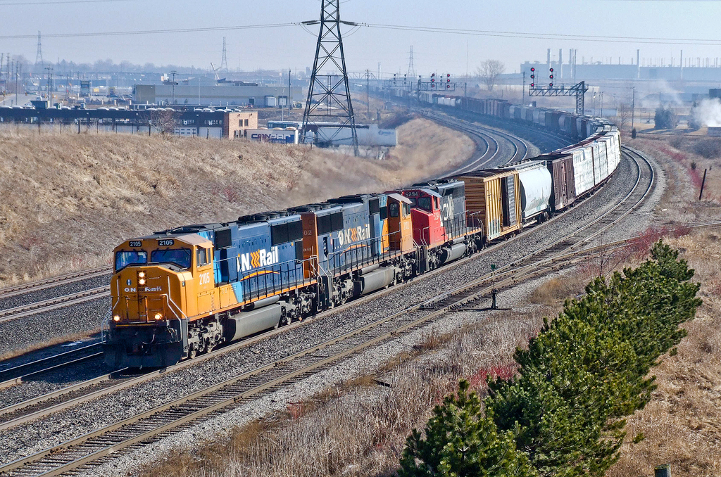 On lease to CN, ONT SD75Is 2105 and 2102 are assisted by CN SD40-2(W) 5294 leading St. John, NB - Toronto MacMillan Yard, ON train M30511 09 westbound at Oshawa West.