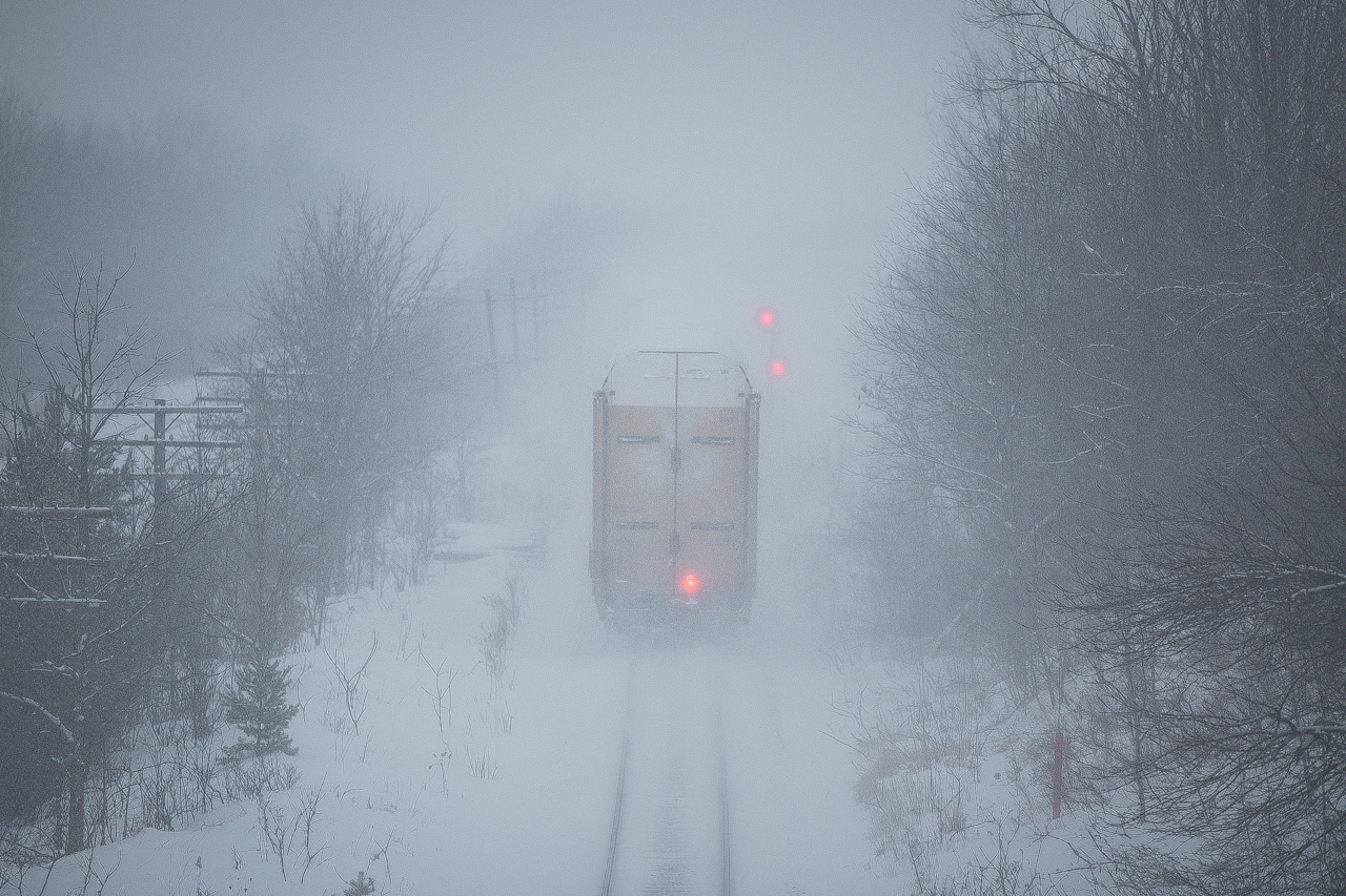 ETD blinks red and the east siding switch Lobo changes to a stop signal as CP 8508 and DME 6363 push loaded auto racks past mile 5.8 CP Windsor Sub in a whiteout...