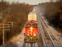CN 2583 leads an intermodal train west out of #ldnont on the CN Strathroy Sub MP 6.5 as the last few moments of sunlight start to fall behind the horizon