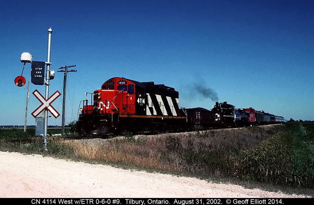 CN 4114 leads the parade as Essex Terminal 0-6-0 #9, and all the support cars, are moved from St. Thomas to Windsor for the 90th Anniversary Celebration on the Essex Terminal Railway.  ETR #9 pulled excursions, utilizing the equipment in tow, on the Essex Terminal for much of the Labor Day Week in 2002 with hundreds of families taking part in riding the train.