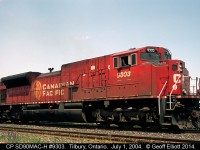 CP SD90MAC-H #9303 makes another appearance on the Windsor Subdivision on July 1st, 2004 as it heads up train #152 today.  9303 is waiting in the siding in Tilbury for 2 westbounds to clear before continuing east.