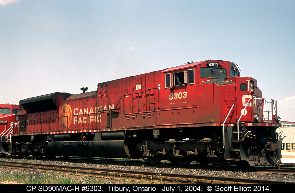 CP SD90MAC-H #9303 makes another appearance on the Windsor Subdivision on July 1st, 2004 as it heads up train #152 today.  9303 is waiting in the siding in Tilbury for 2 westbounds to clear before continuing east.