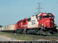 SOO LINE SD60 #6003 leads red sister SD60 #6045 as they pause at Dougal Ave in Windsor for a crew change before heading east on the Windsor Subdivision.