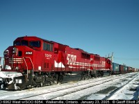 Candy Apple red SOO's adorn this westbound container train as it sits in Walkerville, Ontario on a frigid January 2005 day.  SOO SD60M #6062, with sister SD60 #6054, are frozen to the rails today after sitting in the siding here for a couple of days before being readied to head State side.