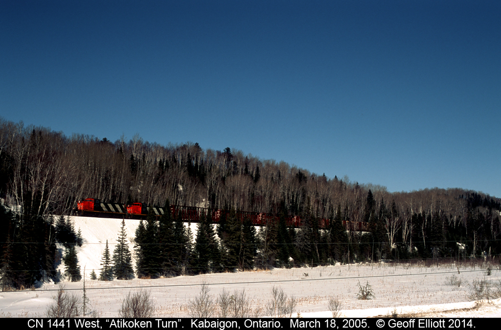 CN 1441 & 1410 lead the Atikoken Turn up a grade just off Highway #11, the Trans Canada Highway, just west of Kabaigon, Ontario.  Wasn't much traffic on this line in 2005 with only 2 trains each way that I'm aware of, so catching one while driving along from Fort Frances to Thunder Bay was always a treat.