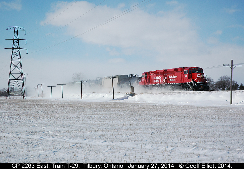 CP 2263 leads CP train T-29 as it rounds the curve in Tilbury, Ontario.  RTC had issues this morning with switches in Windsor which delayed the train's departure.  Once out on the main T-29 was getting restricting and stop signals along the line as the cold and snow was screwing with the signal system.  Eventually they were able to get clear signals and T-29 was able to speed along to Chatham to do it's work.