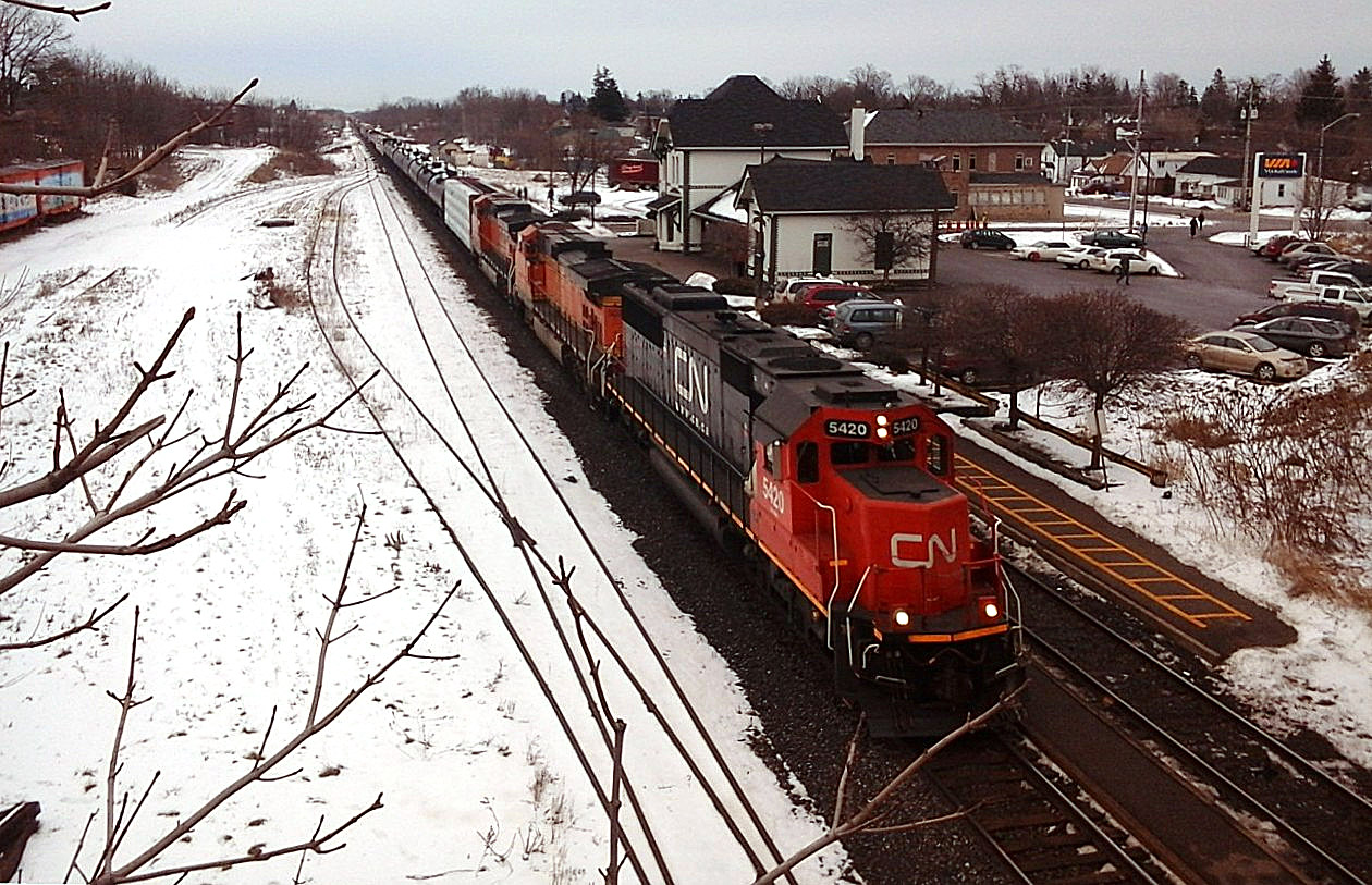 CN 5420 leads BNSF 5021 and BNSF 1123 through Woodstock with train 385 and 144 cars in tow. This is the third time I have seen BNSF power on CN, for a total of 6 locomotives. Thanks Dad for bringing me out to shoot it.