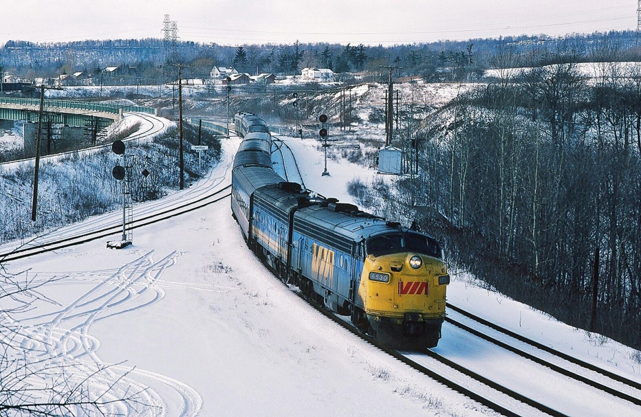 “ Who'd thunk it ? “


First generation diesel power in it's fourth decade.


When you and me ( the federal government ) relieved the railways of passenger service in 1978 – to reduce the deficits, increase efficiencies and reduce duplication – who believed that those F's and FPA's would survive through the 1980's? And some into the 90's?


(And steam ( heat )  alive and well ?)


Perhaps a tribute to the quality of CN's maintenance services ?


And conversely an indication of CP's interest in maintaining passenger service /  equipment ?


Or a condemnation: the acute  lack of funding  ( interest ) in rail  “modernization” ? ( Note that the 'LRC' equipment is now in it's fourth decade ! )


Consider that the forty year old Pickering Airport plan continues to move forward – while Canada's high speed rail, after multiple 'studies' (in various decades),  is where ? And Japan's Bullet Train is now six decades in service?


Do consider: IF high speed rail EVER makes it to Canada – get your passenger pics at Bayview /
 Hamilton Jct. / Hamilton West Jct.  now -  any new high speed line will avoid the sharp curves (slow speeds)  through said junctions ! 


Nevertheless, one of my favourite places Hamilton West Junction, the 1980 version of  train #74 slows to a 15 m.p.h. crawl for the curves and turnouts with the venerable – fourth decade in service -  1957 GMD built FP9A 6530 in charge.


 6530 was retired by 1991.


January 1980 Kodachrome by S.Danko.


More F units? Lots to choose in this website!


Some of my favourites:


 F for Freight !   


 Luv those stripes !   


sdfourty