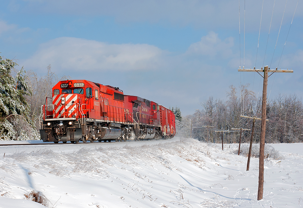 With all hope being lost on shooting a southbound train on the MacTier Sub, my scanner crackled to life when CP 6037 S called the Palgrave mileboard. CP6037 and CP9595 lead CP 420 through Palgrave on this nice winters day.
