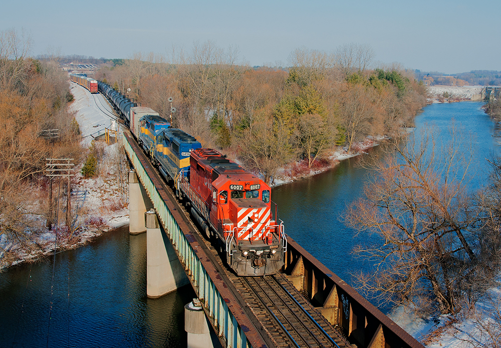 What began as knowing when and where the train was ordered turned into a wild goose chase to Woodstock from Guelph, after meeting CP 254 at Blandford, CP 6007 West eases into Woodstock with a trio of GMD/EMD units.