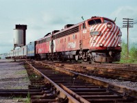 Green Flags !
<br>
<br>
First #122 glides past the CN Washago coaling tower onto the CN Newmarket Subdivision powered by ….strangers in an foreign land.....ex CP Rail FP9A's 1432 (ex 4041) – 1404
<br>
<br>
The 1979 re-routing moved the daily VIA transcontinental from CP Rail's Mactier subdivision to the CN Bala and Newmarket subdivisions. The Employee Timetable does not show this train.  In the meantime – until the new Employee Timetable is in effect - First #122 is the re-routed eastbound Transcontinental acquiring those Green Flags at CN Washago for the trip south on the Newmarket Subdivision to Union. The Second Section of Train #122  -  the Northlander - follows in 2 hours. (CN Bala Sub is in the background at right).
<br>
<br>
May 12, 1979 Kodachrome by S. Danko.
<br>
<br>
<a href="http://www.railpictures.ca/?attachment_id=9804">  same day approach CN Washago </a> 
<br>
<br>
sdfourty
