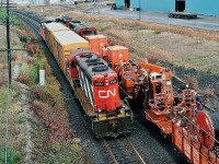 ...continuing the single unit theme...
<br>
<br>
Single geep on a CN freight train.
<br>
<br>
Long hood forward - the way God intended....
<br>
<br>
...and a freight train with a Caboose – the way it should be....
<br>
<br>
Somewhat unusual –  all the local jobs now seem to have at least 2 re-built (chop nose) geeps. 
<br>
<br>
 CN 4351 – Class GR 17z built GMD 1959 -  is the second geep to wear this number, the first 4351 GP7 built GMD 1954 was renumbered to 4801 in 1957 and long retired. (along with 23 other sisters into the 4800 to 4823 series). CN 4351 the second (pictured here) is the future CN 7277 based in Montreal. 
<br>
<br>
 Photo note: with Kodachrome ASA 64 (slow ISO) and with low light necessitated  a wide aperture and a slow shutter speed – likely one one hundred twenty fifth – hence the slight nose / number board blur.
<br>
<br>
October 1991 Kodachrome by S. Danko
<br>
<br>
Another view of the CN Trench-Cable Train:
<br>
<br>
Bet you never wondered how CN's fibre optic cable got into the ground.....the Trench – Cable train is at CN Kingston Subdivision mile 304   (near Lasco Steel -   Hopkins Street ). CN plain SD-40  # 5084 is the future #6007, the other unit may be SD-40W #5339. October 1991 Kodachrome by S. Danko
<br>
<br>
Tech Note: at this time, October 1991, the debate raged on the future technology for the Oshawa GO line: a GO RT – like the Scarborough RT – was being promoted by the Ontario Government !
<br>
<br>
<a href="http://www.railpictures.ca/?attachment_id=9626">  Cable Train  </a> 
<br>
<br>
More single unit (first generation) powered freights:
<br>
<br>
<a href="http://www.railpictures.ca/?attachment_id=5505"> near the Soo   </a> 
<br>
<br>
<a href="http://www.railpictures.ca/?attachment_id=7953"> GP 7   </a> 
<br>
<br>
<a href="http://www.railpictures.ca/?attachment_id=6641"> GP 38-2   </a> 
<br>
<br>
<a href="http://www.railpictures.ca/?attachment_id=5851"> GP 35  </a> 
<br>
<br>
sdfourty