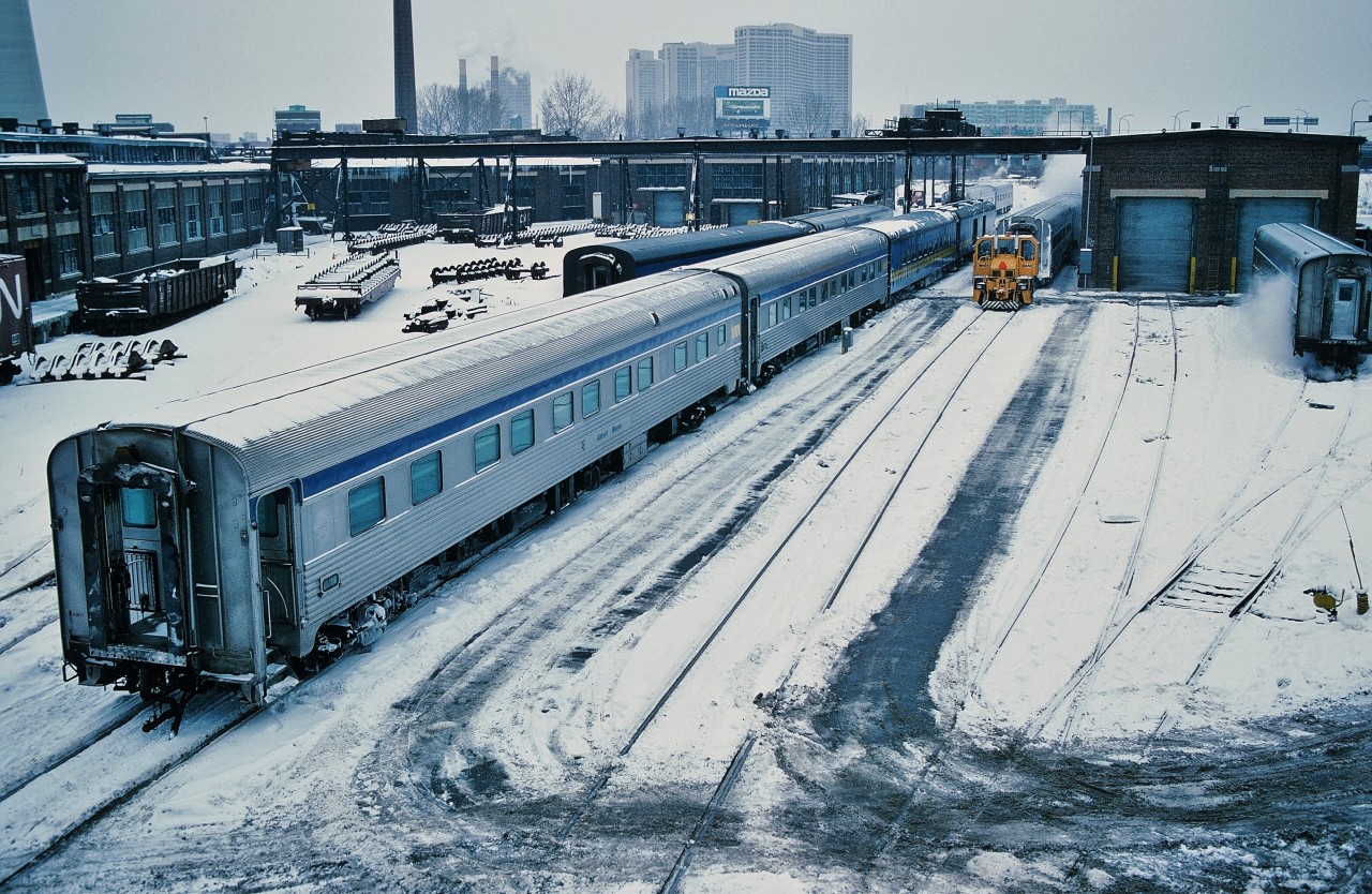 Winter in the City.


Once upon a time one only traveled downtown to see the servicing of mainline passenger equipment.


The ' Other '  View from the Spadina Avenue bridge.


Often – likely mainly – overlooked was the area south of the CNR Spadina Roundhouse.


…..and for the modelers: what to do with that area behind the roundhouse.....


Here, the (ex) CNR Spadina Coach Yard Shop remains a busy place....


...and steam (heat)  still rules !


With ' foreign ' (ex CP Rail) passenger equipment.


And the Trackmobile is busy with a couple of Budd built (ex CP Rail) sleeping cars.


At immediate left the ex CP Rail Abbott Manor sleeping car is the second of two Manor sleepers – possibly part of the consist for Via Rail  train #58 and the car next to the Baggage appears to be a (ex CN )  Dayniter providing the “ VIA 1 “  service on the Cavalier (Montreal overnight train).


January 20, 1985 Kodachrome by S. Danko.


More Spadina Bridge: 


 Another 1985 view from the Spadina Bridge 


 a view of the Bridge  


 classic  


 same view different time  


 contrasting cabs  


sdfourty


p.s. upper left: that is the base of the CN Tower.