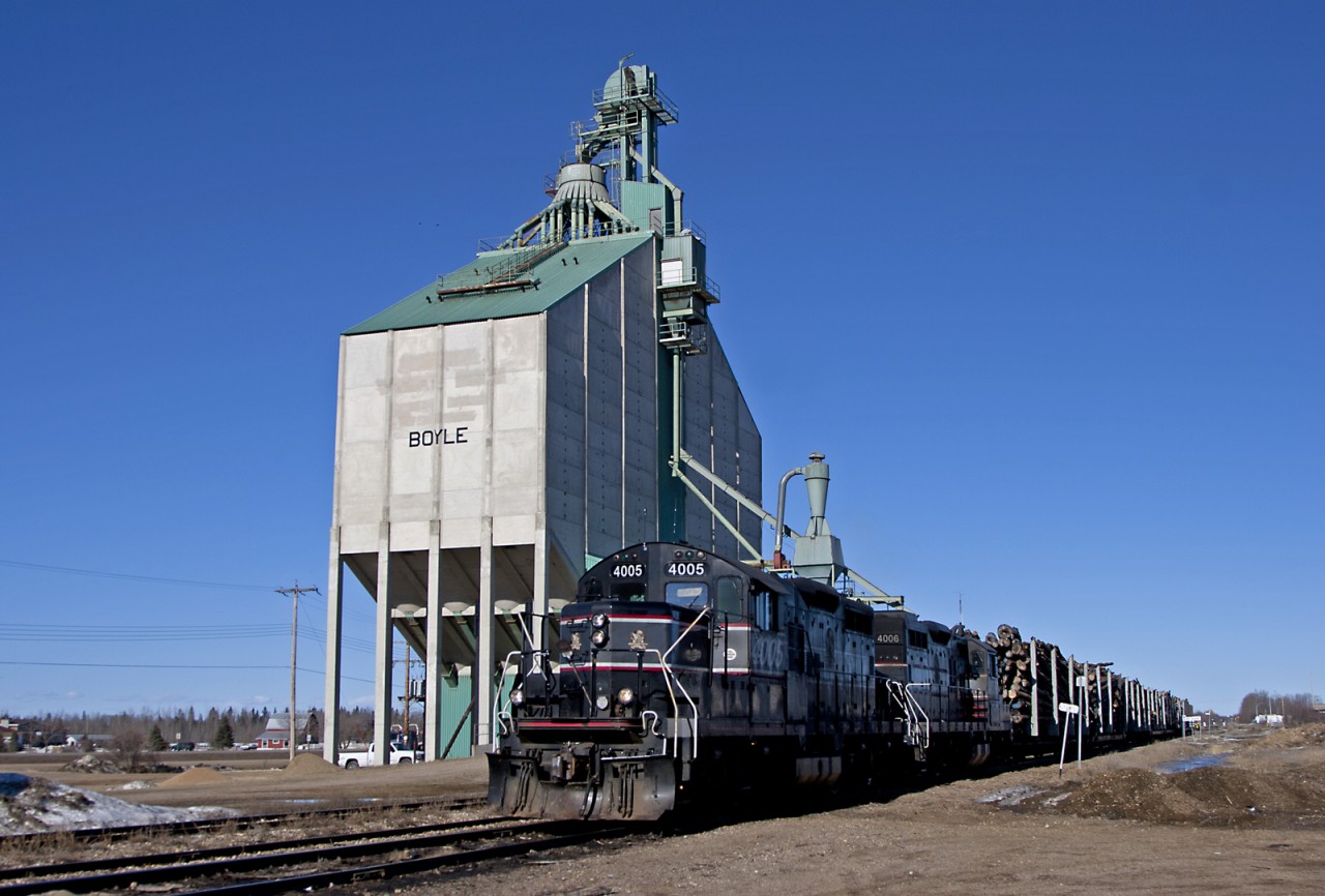 Athabasca Northern freight pauses besides the unique elevator in the small community of Boyle