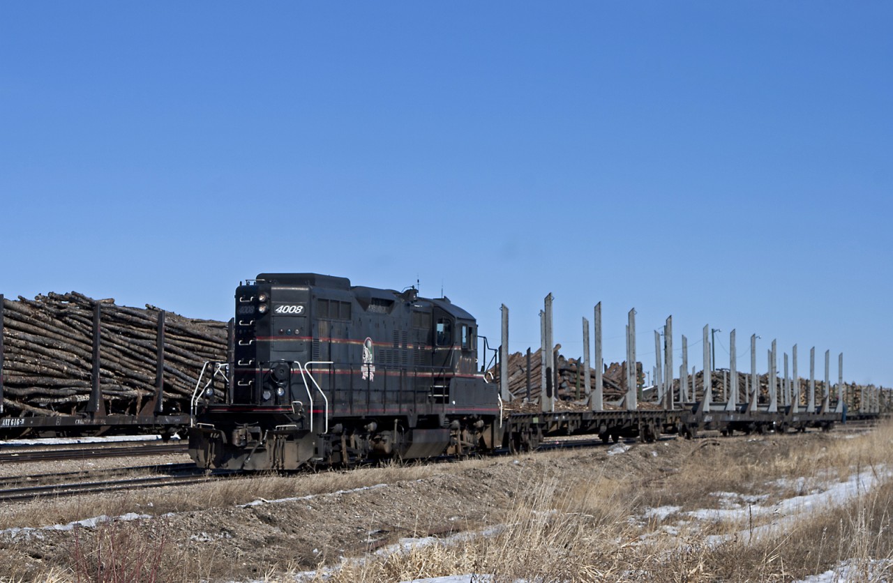 Athabasca Northern GP9RM #4008 switches empty log flats in the yard at Lac La Biche