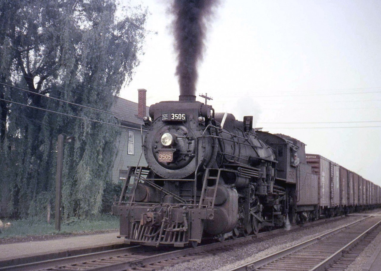 Canadian National 3505, a 2-8-2 "Mikado", heads westbound past the platform at CN's Clarkson Station (located by Clarkson Road, east of the current GO station and freight yards) in 1957.