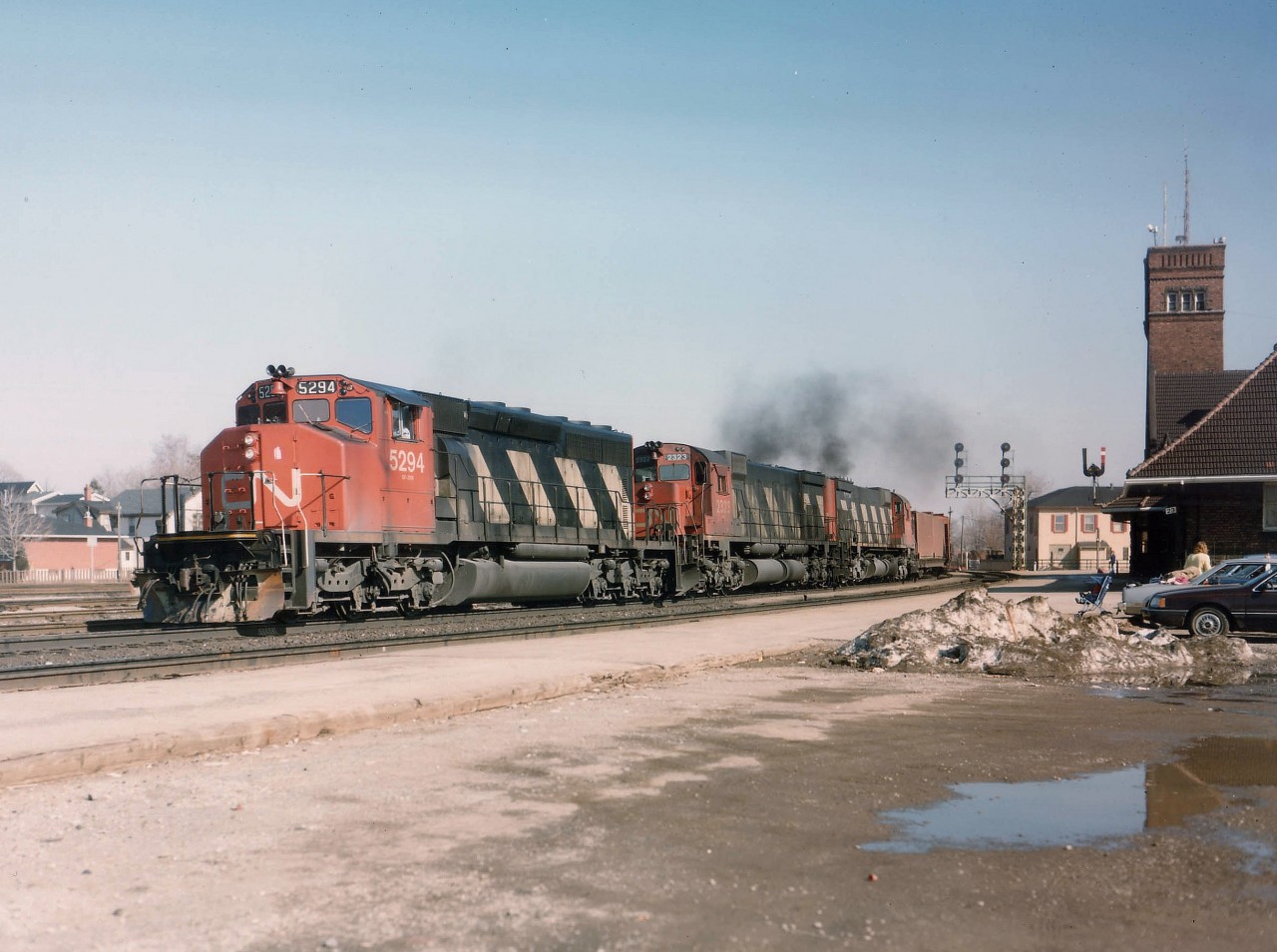 Here at now probably the best location to catch traffic on the CN Dundas Sub (due to good parking and a coffee shop)a westbound roars by the station area with CN 5294, 2323 and 2013. It almost looks as if spring has arrived, but no it is only the beginning of March. Image captured using Speed Graphic and colour sheet film.