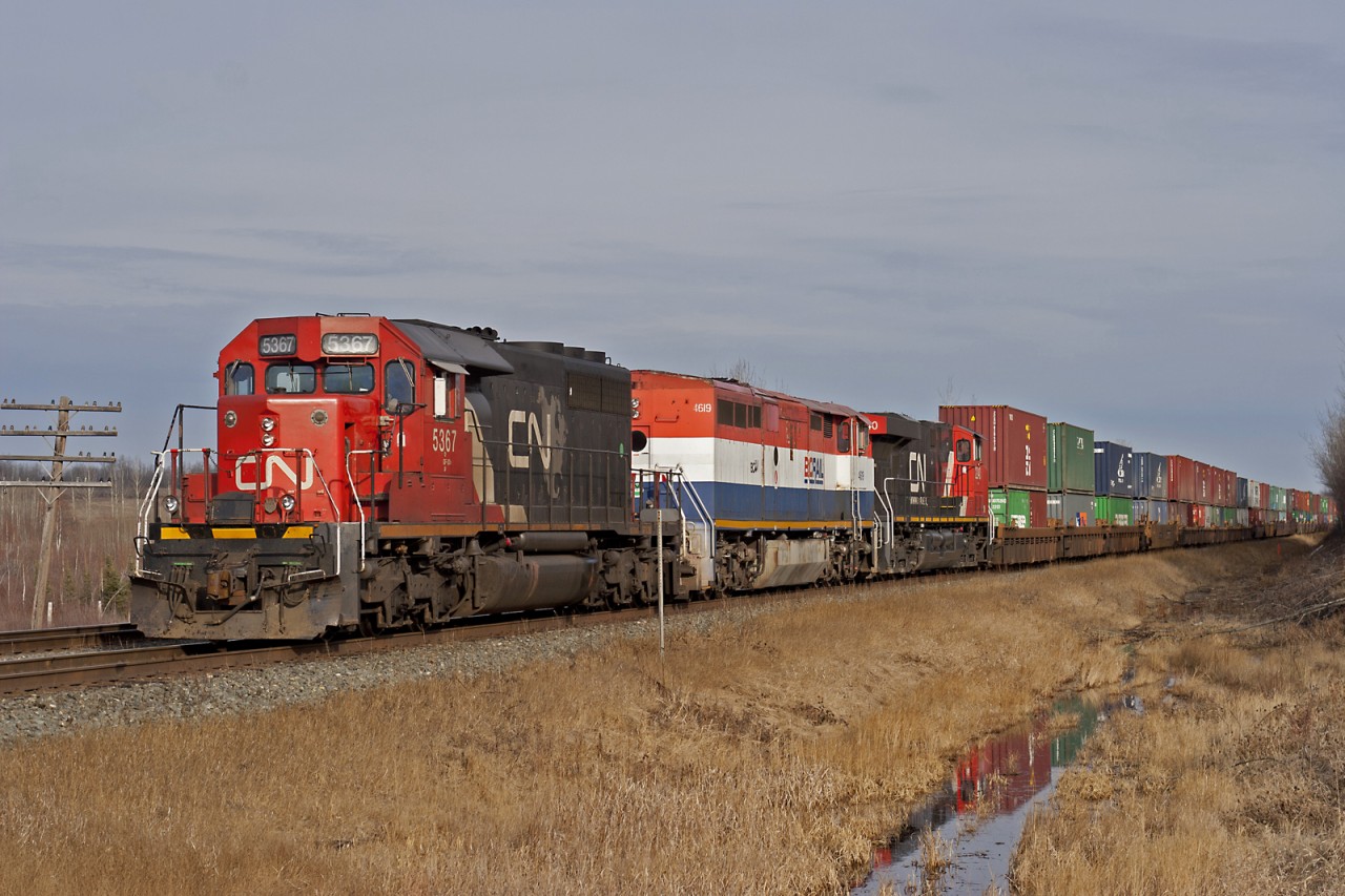 Wstbound intermodal with an SD40-2,  Dash 840CM, and ES44DC wait in the siding at Kapasawin