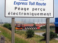 <b>The Zebra Hunter</b>.
<br><br>
That day it was The Pumpkin Hunter, at least initially. This one may be familiar to some: a now-retired CN zebra-striped SD50F 5439 leads new BNSF "pumpkin" GEVO 7739 and another CN unit on train #338, sitting west of the Humber River waiting for a light power move heading to the Brampton Intermodal Terminal. All nicely framed in the Hwy 407 ETR sign by the Hwy 27 overpass.
<br><br>
That new BNSF pumpkin GEVO was the goodie of the day, and 338 had it. After driving around and scouting a few subpar spots, I received an update that he was nearby, so parked at the brown brick building in the background and headed up the overpass to intercept. Waiting around for a bit, there was no sign of him so I reluctantly headed back down. As I got back to the car and hopped in ready to leave, I look to my right and see 338 pull under the overpass and stop right there, with the BNSF unit in view. So, back up the bridge we go to shoot it from the sunny side!
<br><br>
Fortunately they stopped on the less-cluttered side of the overpass, with the BNSF just past the bridge, allowing me to nab some side shots of her. This one of the lead unit stands out most though. While the similar-looking CN SD60F fleet keeps racking up the miles, the SD50F is all but extinct.