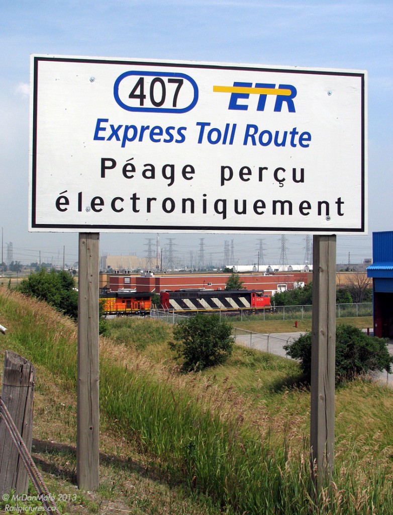 The Zebra Hunter.

That day it was The Pumpkin Hunter, at least initially. This one may be familiar to some: a now-retired CN zebra-striped SD50F 5439 leads new BNSF "pumpkin" GEVO 7739 and another CN unit on train #338, sitting west of the Humber River waiting for a light power move heading to the Brampton Intermodal Terminal. All nicely framed in the Hwy 407 ETR sign by the Hwy 27 overpass.

That new BNSF pumpkin GEVO was the goodie of the day, and 338 had it. After driving around and scouting a few subpar spots, I received an update that he was nearby, so parked at the brown brick building in the background and headed up the overpass to intercept. Waiting around for a bit, there was no sign of him so I reluctantly headed back down. As I got back to the car and hopped in ready to leave, I look to my right and see 338 pull under the overpass and stop right there, with the BNSF unit in view. So, back up the bridge we go to shoot it from the sunny side!

Fortunately they stopped on the less-cluttered side of the overpass, with the BNSF just past the bridge, allowing me to nab some side shots of her. This one of the lead unit stands out most though. While the similar-looking CN SD60F fleet keeps racking up the miles, the SD50F is all but extinct.