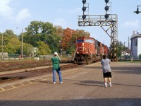 Future RPca contributors Peter and Mark are shown honing their photography skills on CN 5744 as she leans into the right hand sweeping curve past the Brantford train station. Fall colours on this Thanksgiving holiday Monday are clearly emerging as the shade of the tree in background almost matches the red-orange applied to the wide nose of the GMD built (10/1997) SD75I.