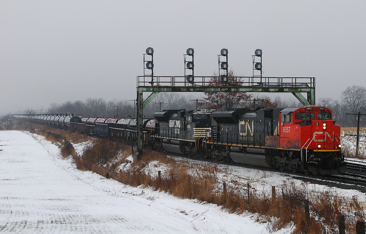 331 with CN 8857 - NS 1055 pull under the signal bridge at Paris West with a 63 car lift