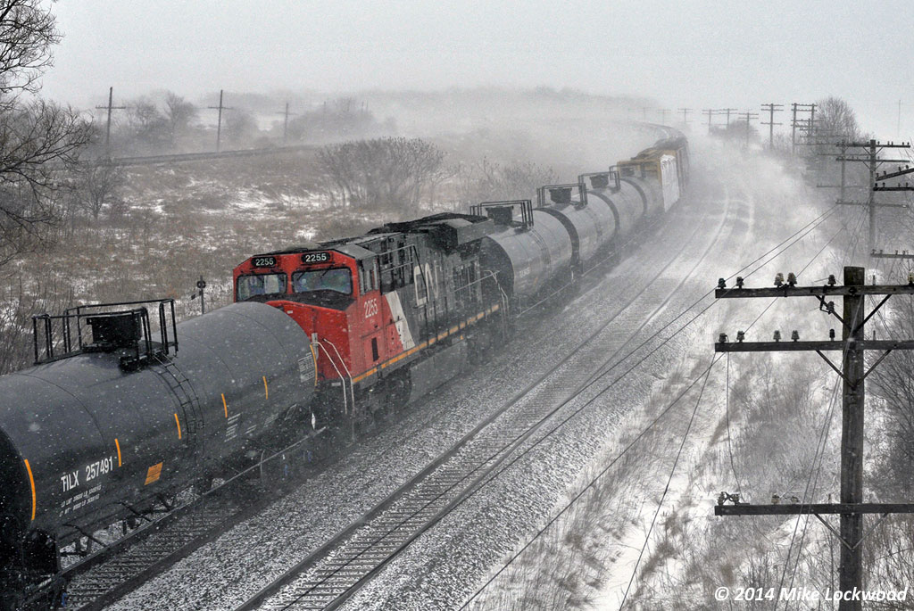 I love winter. On days when it snows sideways and flying ice pellets sting your face, I can't think of a better time to photograph trains... pra-praprapra. CN 2255 as the DPU on train 376 at Lovekin. 1427hrs.