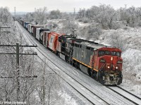 In the midst of a somewhat surreal, monochrome aftermath of the December 21st ice storm, CN 2444 and 2319 climb upgrade with 376's train. Getting one of the very few remaining Sclair hoppers first out on the train was a nice touch. 1346hrs.