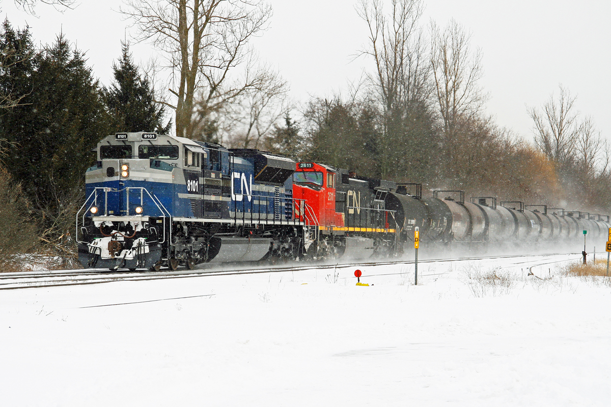 Light snow is falling as one of CN's latest acquisitions still in EMD demonstrator paint leads train 331 at Copetown, ON.