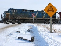 <b> STOP BEFORE CROSSING </b> is a suggestion usually ignored by the majority of drivers at rural railway grade crossings, sometimes with fatal consequence. Remaining pieces of a Dodge pickup lay scattered along the side of the road as a fresh reminder of what can happen when things don't go as planned. This was the sight of a collision earlier last week between the second locomotive of an eastbound CP much like this one. Luckily both occupants survived although quite shaken. Parts lay strewn over the area for about two hundred feet passed the sight of impact, yet still today I witnessed over a dozen vehicles blow right through this crossing without even a glance...

A link to the news article about the incident is posted below for those interested.
http://www.chathamdailynews.ca/2014/01/23/train-collides-with-vehicle