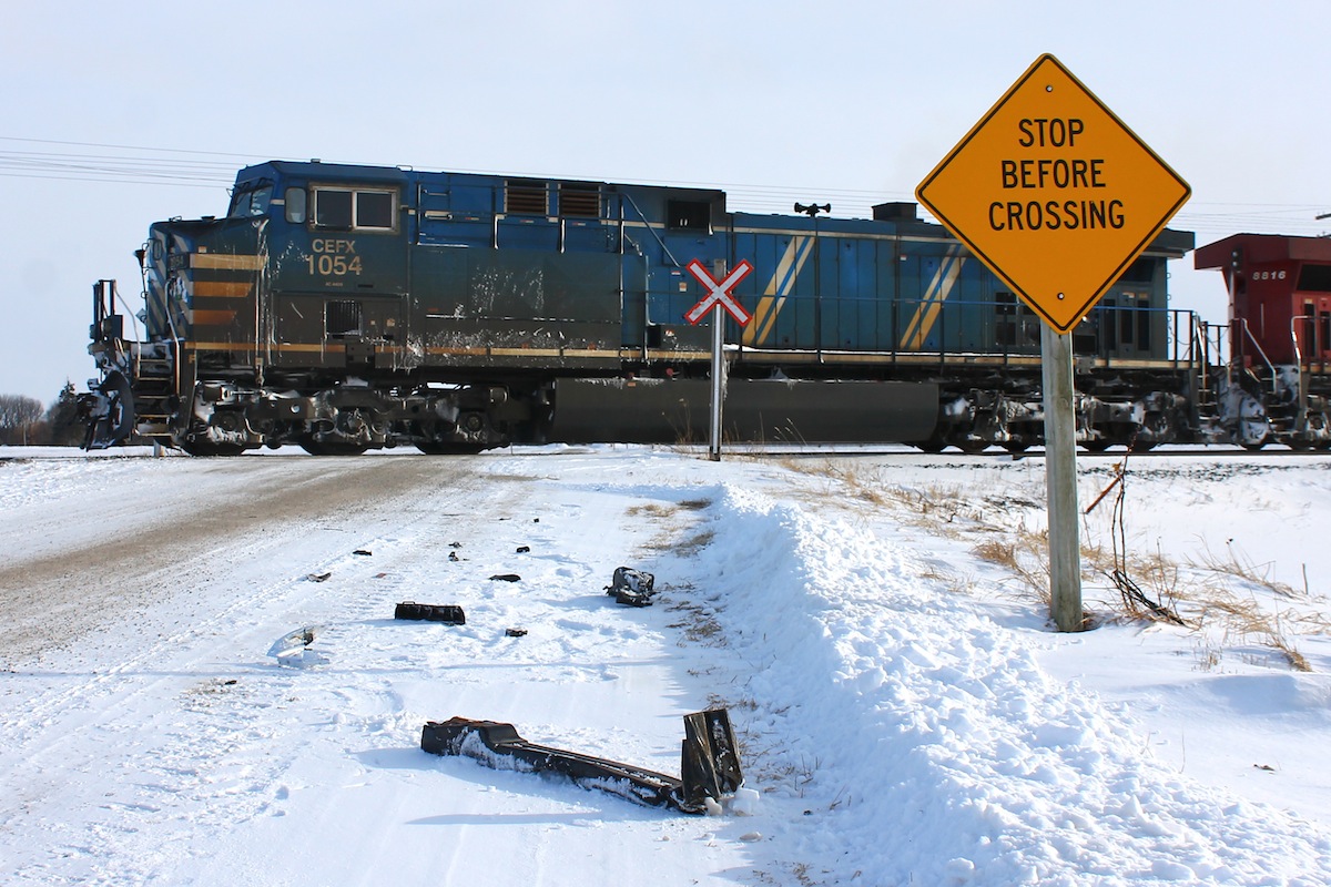 STOP BEFORE CROSSING  is a suggestion usually ignored by the majority of drivers at rural railway grade crossings, sometimes with fatal consequence. Remaining pieces of a Dodge pickup lay scattered along the side of the road as a fresh reminder of what can happen when things don't go as planned. This was the sight of a collision earlier last week between the second locomotive of an eastbound CP much like this one. Luckily both occupants survived although quite shaken. Parts lay strewn over the area for about two hundred feet passed the sight of impact, yet still today I witnessed over a dozen vehicles blow right through this crossing without even a glance...

A link to the news article about the incident is posted below for those interested.
http://www.chathamdailynews.ca/2014/01/23/train-collides-with-vehicle