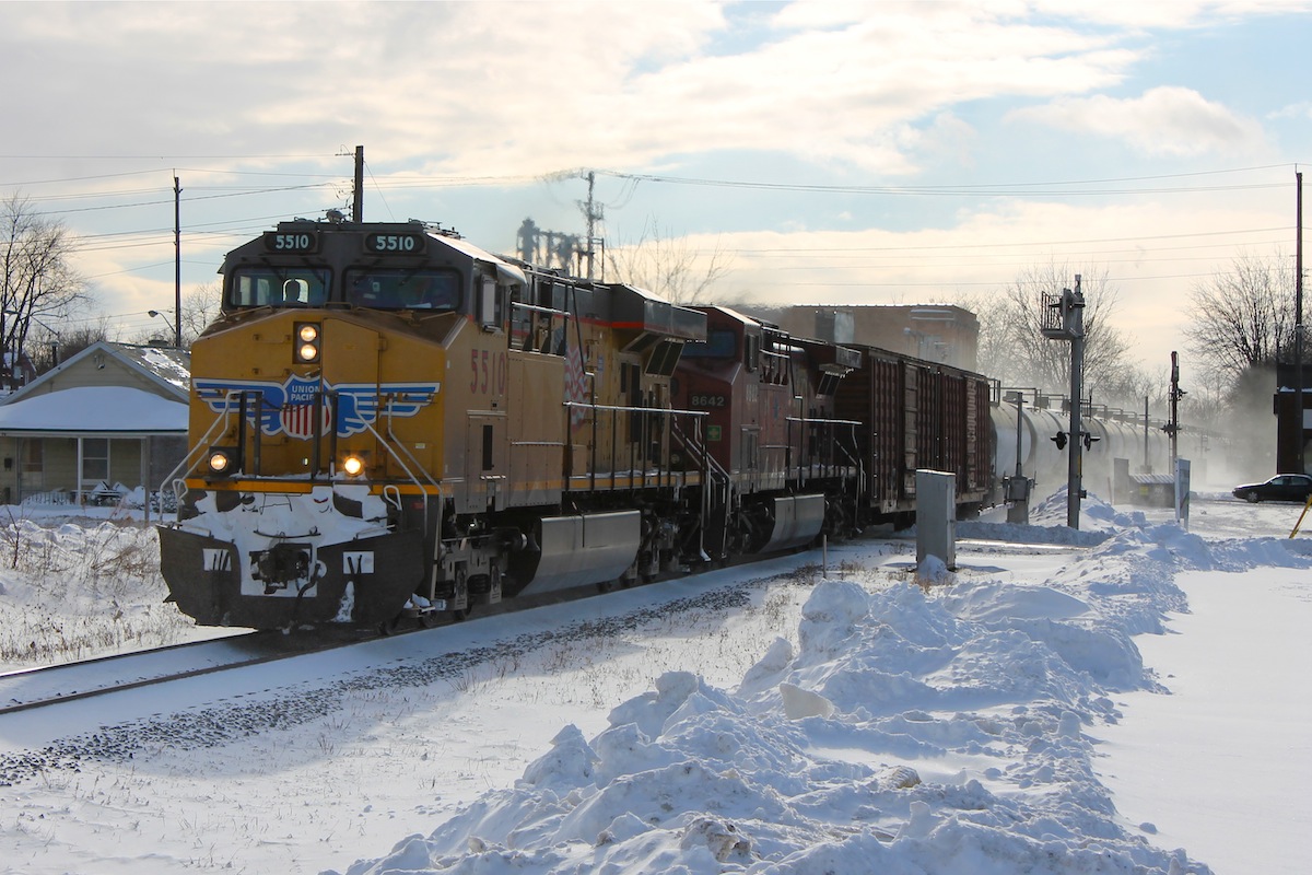 With the short days of winter and working full-time I rarely get a chance to make it trackside anymore before nightfall, and even more rarely get a decent train the cooperates with my schedule. Fortunately things worked in my favour today and just as I was finishing work I got word of a Union Pacific leading an Eastbound, so after a quick dash home to grab my camera and back to the tracks I set up my shot just barely making it before the train. Talk about luck! The only unfortunate part of the whole situation is the terrible afternoon winter light that is trying its hardest to ruin my shot.