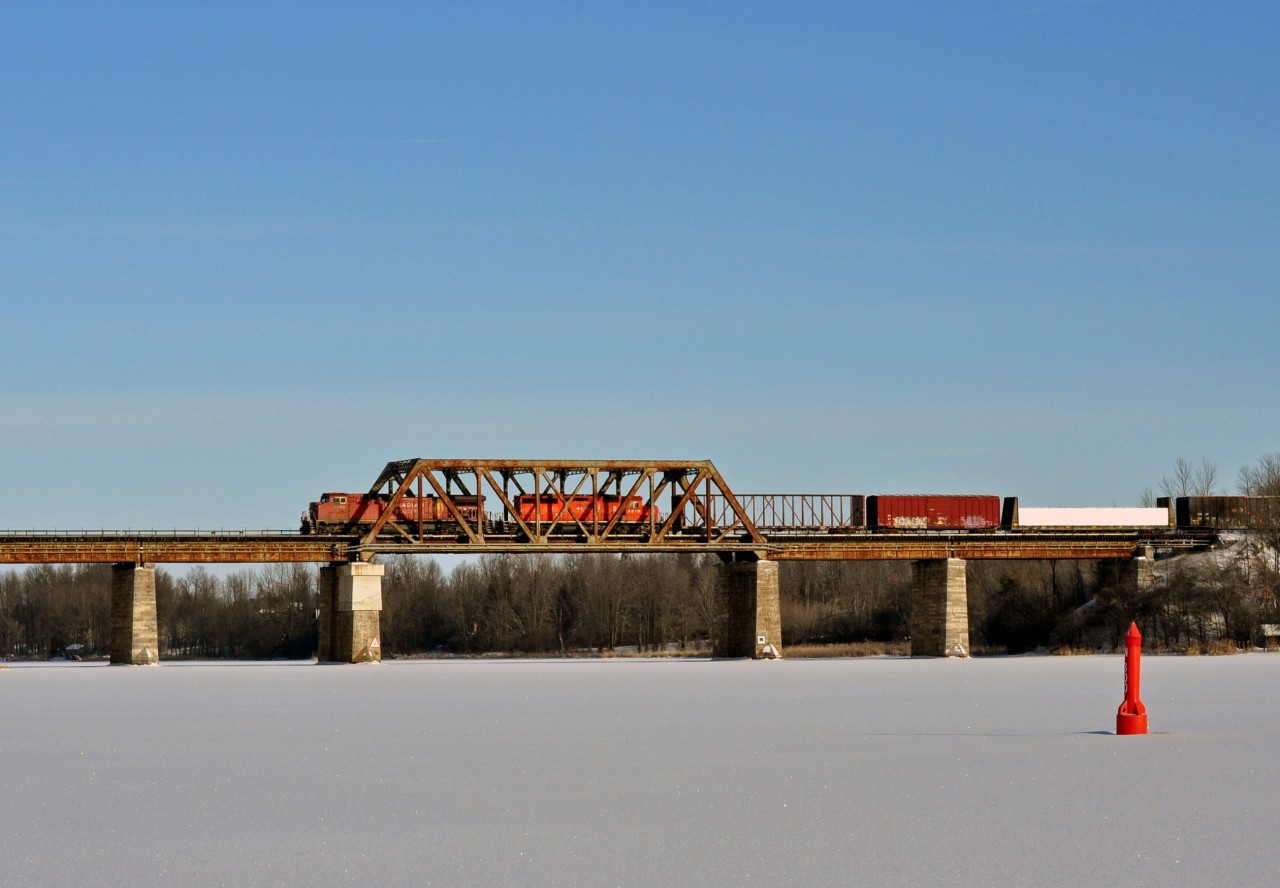 CP 9658 and 5919 lead a westbound manifest across the Rideau river on a bitterly cold new years day.