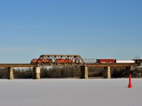 CP 9658 and 5919 lead a westbound manifest across the Rideau river on a bitterly cold new years day. 