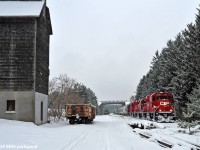 The former Good Grain Company elevator silently observes the passage of the Kawartha Lakes Railway's eastbound roadjob T08 behind CP 2250, 3105, 2254, and 8209 with 30 cars (29 of which are for Unimin). The 8209 will be setout at Peterborough for a stint as the Peterborough Switcher, replacing the 8206. 1242hrs.

<br>Not evident in the photo, work to restore the elevator has seen both the west and south sides refaced with new shingles, and the awning on the south side replaced after being absent for a few years. With luck, the annex on the west side will be rebuilt some day, as all that remains are the crumbling foundations.

<br> The gondola, SOO 63859, likely in OCS service, rests on the remnants of the siding that served the elevator, sitting almost exactly where boxcars of grain were once loaded. This is the furthest east I've seen them shove a car on the now stub ended siding, used more for parking MofW equipment and once, at least that I've seen in the past six years, eight loads from Unimin setout for reasons unknown (possibly reducing tonnage due to power problems). The siding switch is just out of sight around the bend behind the train.