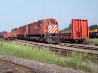 Canadian Pacific M636 4711 is shown along with 4723 and an unidentifiable sister resting at the former T, H & B Aberdeen Yard in Hamilton. In an attempt to prolong the lifespan of the veteran six-axle MLW fleet, in 1988 CP had M636 4711 rebuilt with a like horsepower Caterpillar 3608 Marine Service prime mover at Peaker Services in Brighton, Michigan. Apparently the new prime mover required considerably more breathing capacity as evidenced by the enlarged and expanded carbody filter arrangement (compared to 4723). Note also the relocated horns and lack of multi-mark emblem at the rear of the hood. While successful, the overall expenditure was considered to be cost prohibitive and no further units were so modified. Nevertheless, the transplant did by her an additional three years of service with CP compared to the rest of big MLW’s which had been displaced by the incoming horde of GE AC4400CW’s. Sold to Minnesota Commercial Railroad in July 1998 and renumbered, the venerable unit continues to soldier on with her replacement power plant. Following a period of storage 71 returned to service in mid-2011. The Caterpillar sound is quite distinct from the original Alco 251 ‘chug, chug, chug’. For a sample of her music go to http://www.youtube.com/watch?v=lBYUcRqIsHE
