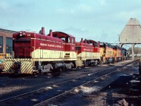An afternoon view of power laying over at the TH&B Chatham St. shops. In the foreground, TH&B switchers 56 & 53, in behind a trio of GP38-2s for the "Nanticoke" steel train: Chessies: 4801, 3885 and 4828.