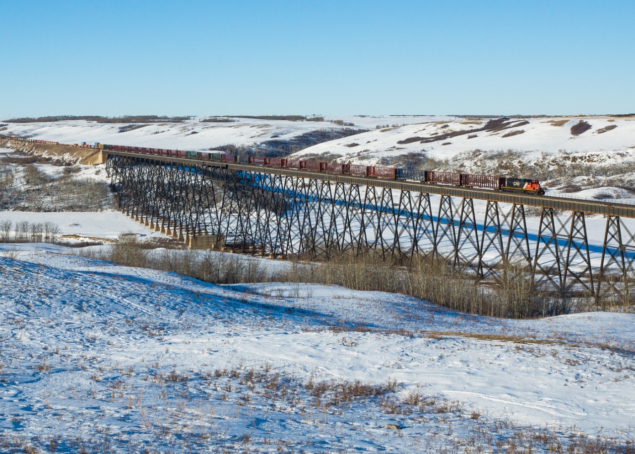 Hitchin' a ride. On a beautiful Saturday afternoon, CN ordered a crew to take an engine west to Tofield and then head back east, picking up junk, bad orders and other cars on their way. Instead of heading light and LHF for 100+ miles, they decided to hitch a ride on Q199, which also had a bunch of empty centerbeam cars on the tailend.