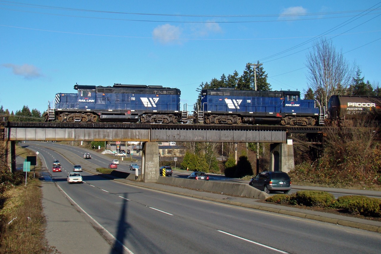 SRY GP-9's 110 and 119 cross the Trans-Canada Highway as they head for the junction with SRY's Victoria Sub