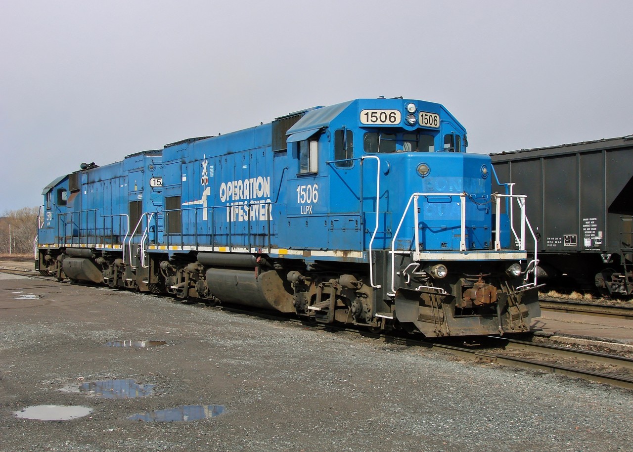 Former Conrail GP15-1's leased to the Cape Breton & Central Nova Scotia Railway idle by the yard office in Stellarton.