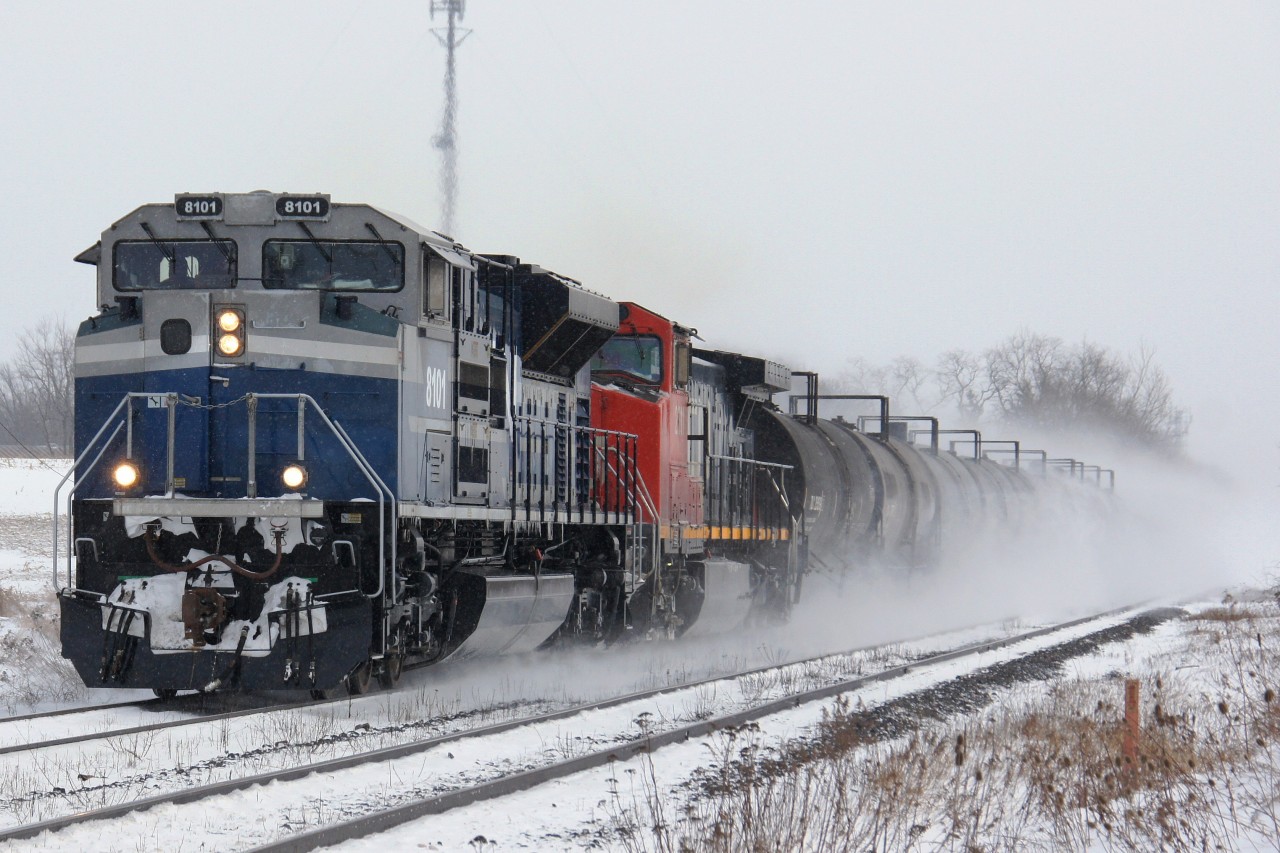 Just a few minutes after James Gardiner shot it at Brantford, 8101 and 2611 kick up snow as they speed by me at Powerline Road. Thanks also to Joseph Bishop for assistance in the chase from Copetown. With high horsepower and no work at Brantford or Paris, there was no safe bet as to where to catch this train, and I arrived at the crossing with only seconds to spare before the gates went down.