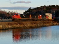 Dash 9-44CWs 2635, 2567 and 2503 lead CN 121 past Moirs Pond.