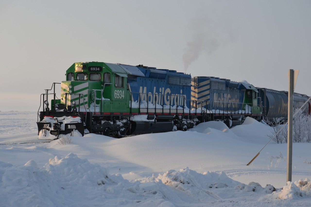 Mobil Grain sits at Delisle SK., waiting to proceed onto the CN Rosetown Sub. following a major snowstorm in the region. This train would travel east on the Rosetown Sub, via trackage rights to the CN Saskatoon yards.