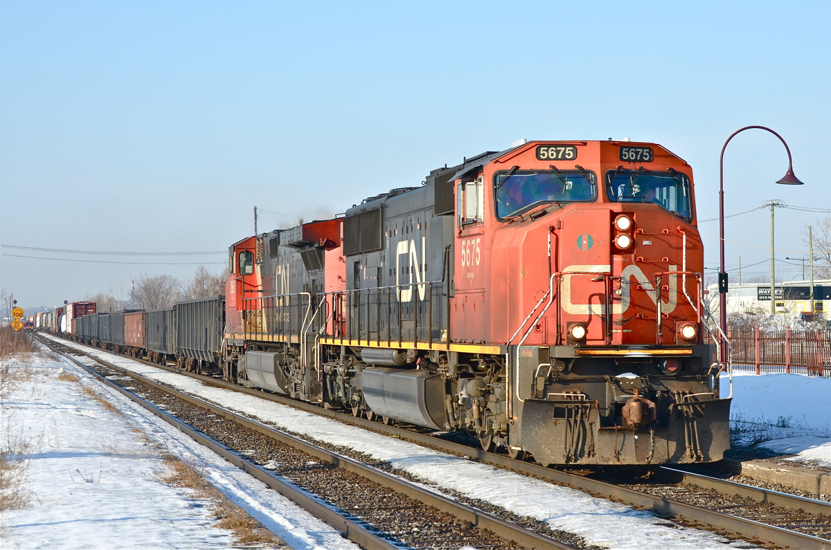 CN 5675 & CN 2680 head east through Dorval with CN 310 on a mild and sunny winter morning. For more train photos, click here.