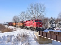 CP 608 led by CP 8869 and a pair of BNSF trailing passes by a farmers crossing on its way eastbound towards London.